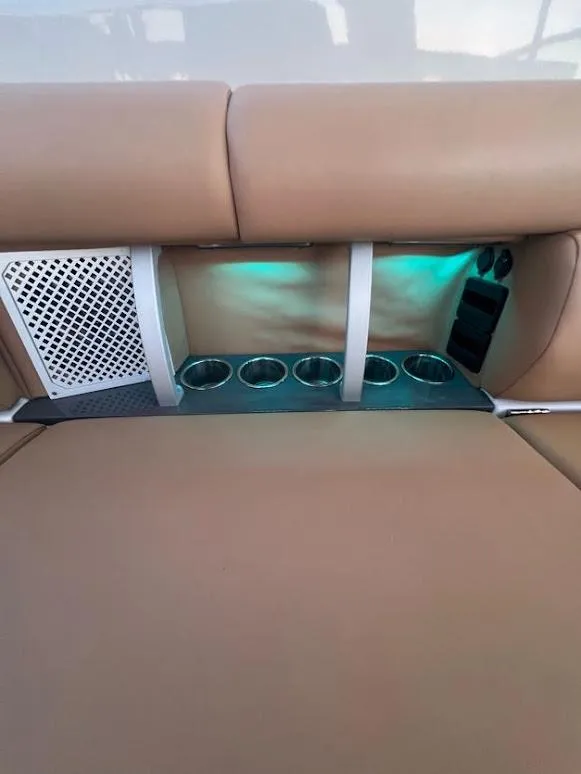 Slide: The Image of 2023 Aviara AV32 OB boat interior with cup holders and ambient lighting. - 21