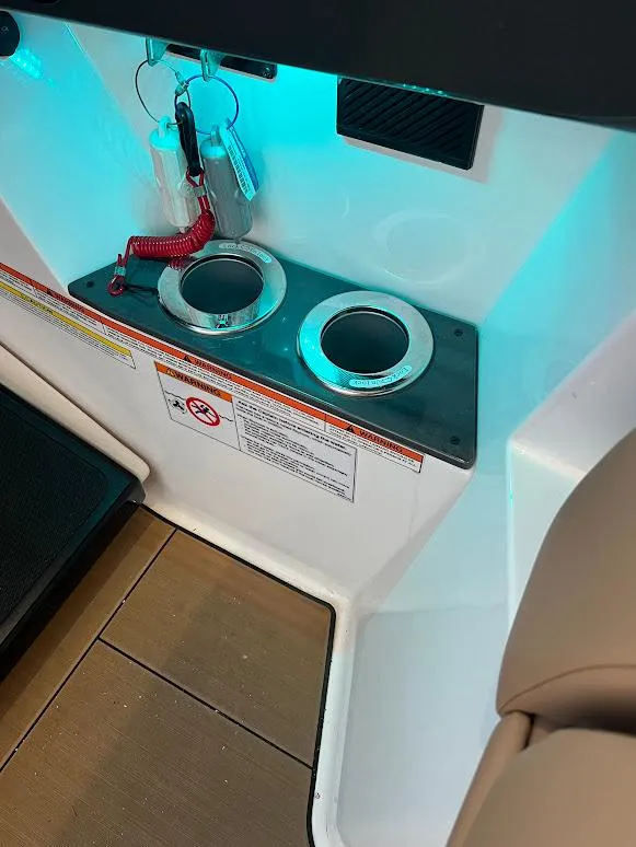 Slide: The Image of 2023 Aviara AV32 OB boat interior with cup holders and key fobs. - 22