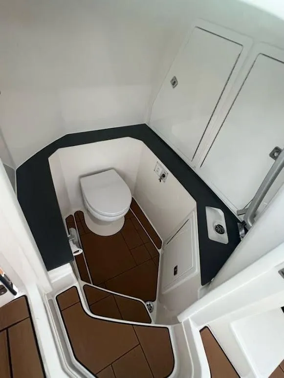 Slide: The Image of 2023 Aviara AV32 OB boat interior bathroom with modern fixtures and wood flooring. - 24