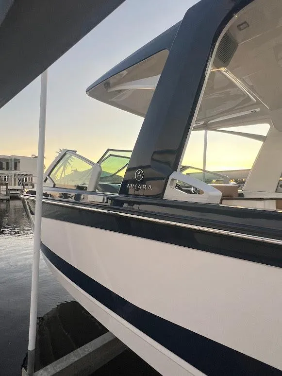 Slide: The Image of 2023 Aviara AV32 OB boat docked at sunset, showcasing sleek design and modern features. - 26