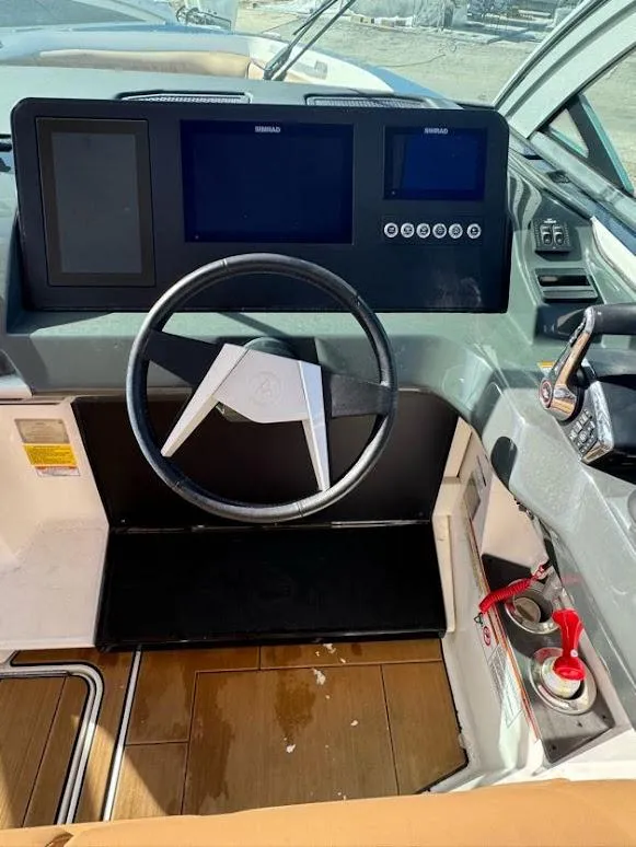 Slide: The Image of 2023 Aviara AV32 OB boat dashboard with steering wheel and control panel. - 7