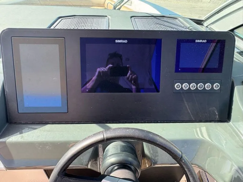 Slide: The Image of Dashboard of 2023 Aviara AV32 OB boat with Simrad displays and steering wheel. - 8