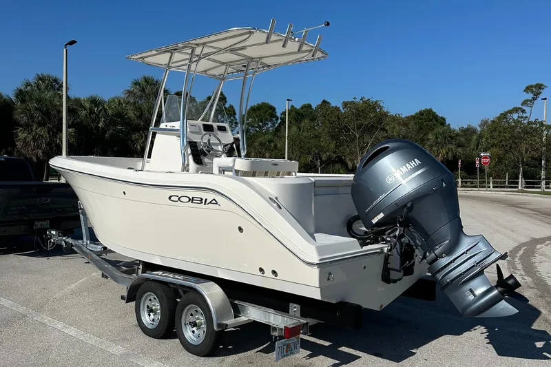 Slide: The Image of 2022 Cobia 201 Center Console boat on trailer with Yamaha outboard motor. - 2