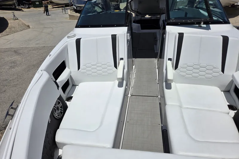 Slide: The Image of 2025 Four Winns H9 OB boat interior with white seating and modern design. - 15