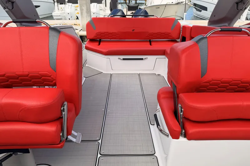Slide: The Image of 2025 Four Winns H9 OB boat interior with vibrant red seating and modern design. - 13