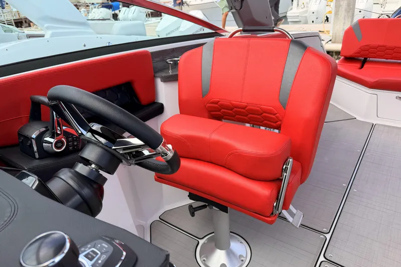 Slide: The Image of Red captain's chair and steering wheel in 2025 Four Winns H9 OB boat cockpit. - 14