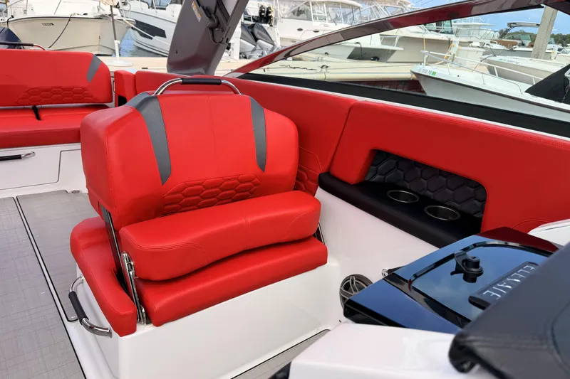 Slide: The Image of 2025 Four Winns H9 OB boat interior with red seating and modern design. - 16