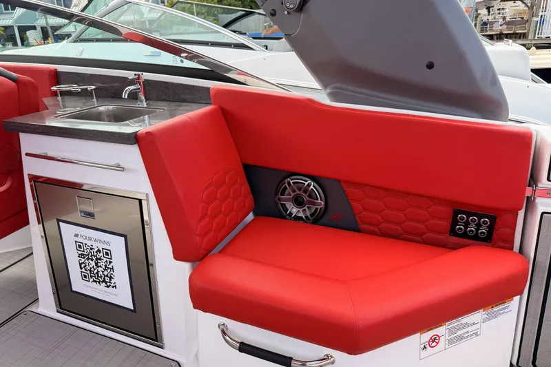 Slide: The Image of Red seating and kitchenette on 2025 Four Winns H9 OB boat, featuring modern design elements. - 17