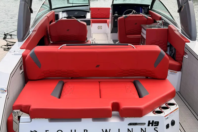 Slide: The Image of 2025 Four Winns H9 OB boat with luxurious red seating and modern interior design. - 18