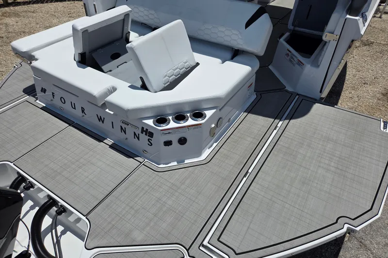 Slide: The Image of 2025 Four Winns H9 OB boat interior with seating and deck details. - 10