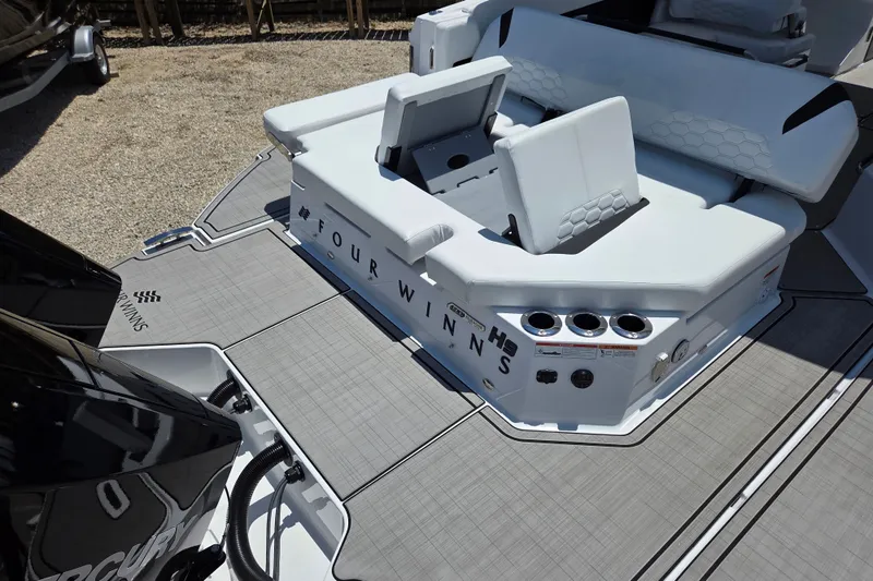 Slide: The Image of 2025 Four Winns H9 OB boat interior with seating and cup holders. - 9