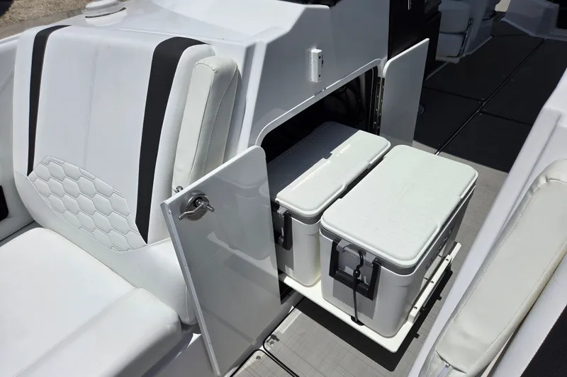 Slide: The Image of 2025 Four Winns H9 OB boat interior with storage compartment and coolers. - 19