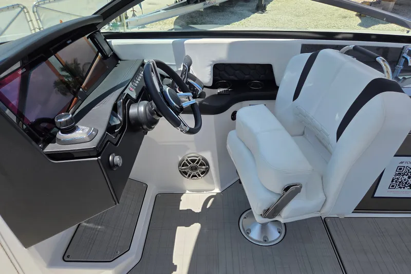 Slide: The Image of 2025 Four Winns H9 OB boat cockpit with modern steering and white seating. - 6