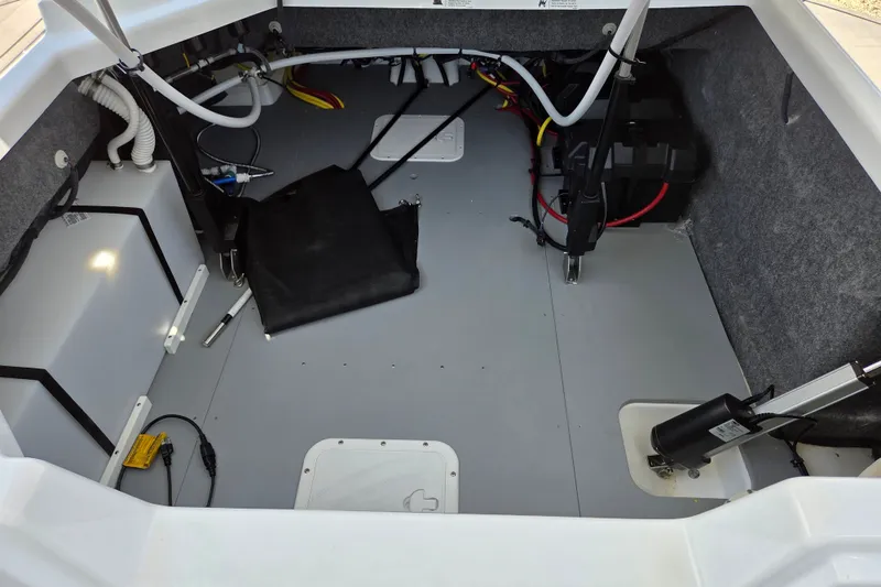 Slide: The Image of Interior view of 2025 Four Winns H9 OB boat, showcasing storage and wiring. - 12