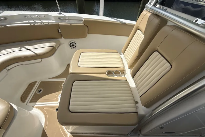 Slide: The Image of 2016 Sea Fox 266 Commander boat interior with tan cushioned seating and cup holders. - 18
