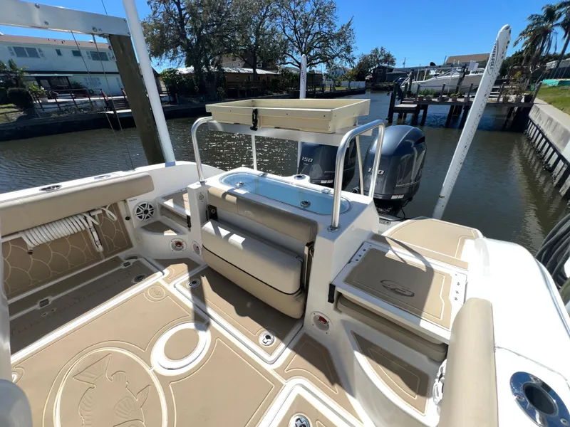 Slide: The Image of 2016 Sea Fox 266 Commander boat interior with seating and storage, docked by a canal. - 19
