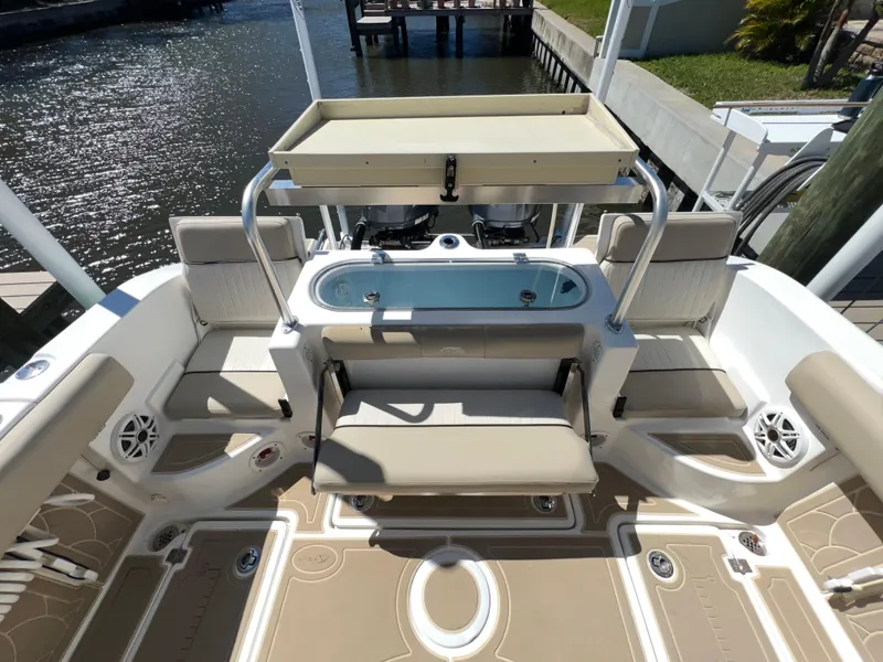 Slide: The Image of 2016 Sea Fox 266 Commander boat interior with seating and storage near water. - 21