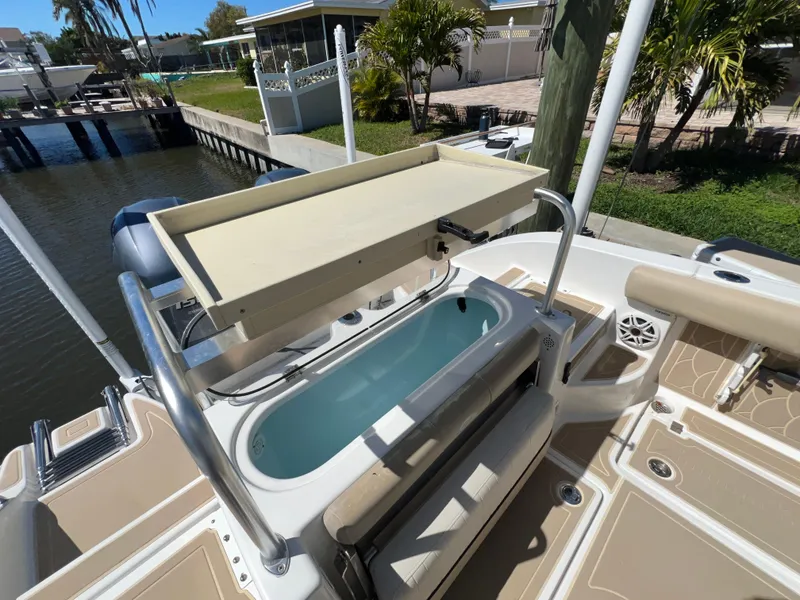 Slide: The Image of 2016 Sea Fox 266 Commander boat with fishing station and livewell, docked by a canal. - 24