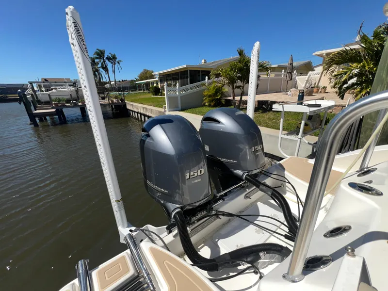Slide: The Image of 2016 Sea Fox 266 Commander with twin 150 horsepower engines docked by waterfront homes. - 26