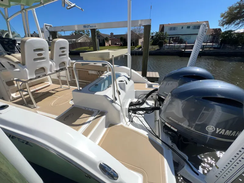 Slide: The Image of 2016 Sea Fox 266 Commander boat with dual Yamaha engines docked by waterfront homes. - 27