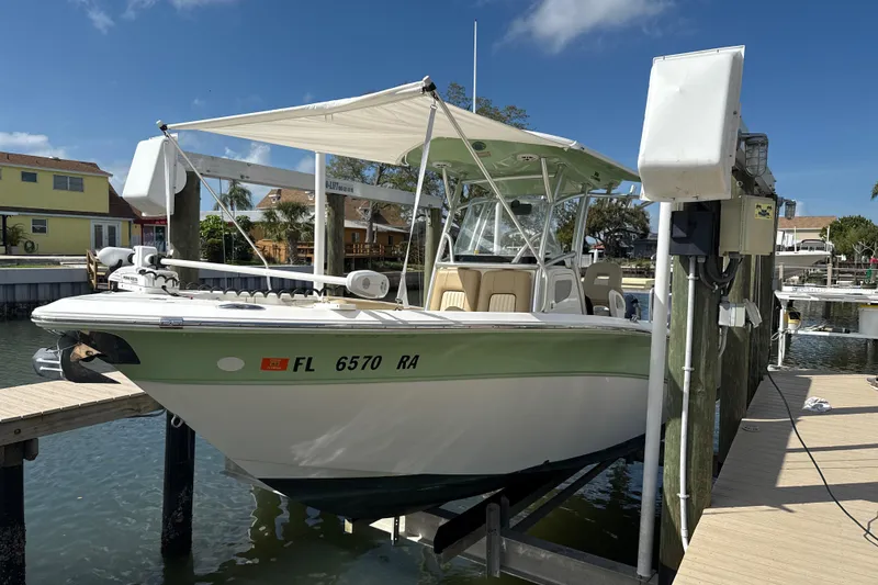Slide: The Image of 2016 Sea Fox 266 Commander boat docked at marina under clear blue sky. - 3
