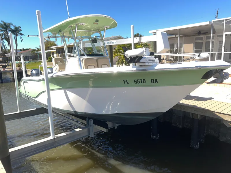 Slide: The Image of 2016 Sea Fox 266 Commander boat docked, featuring a sleek design and green accents. - 36
