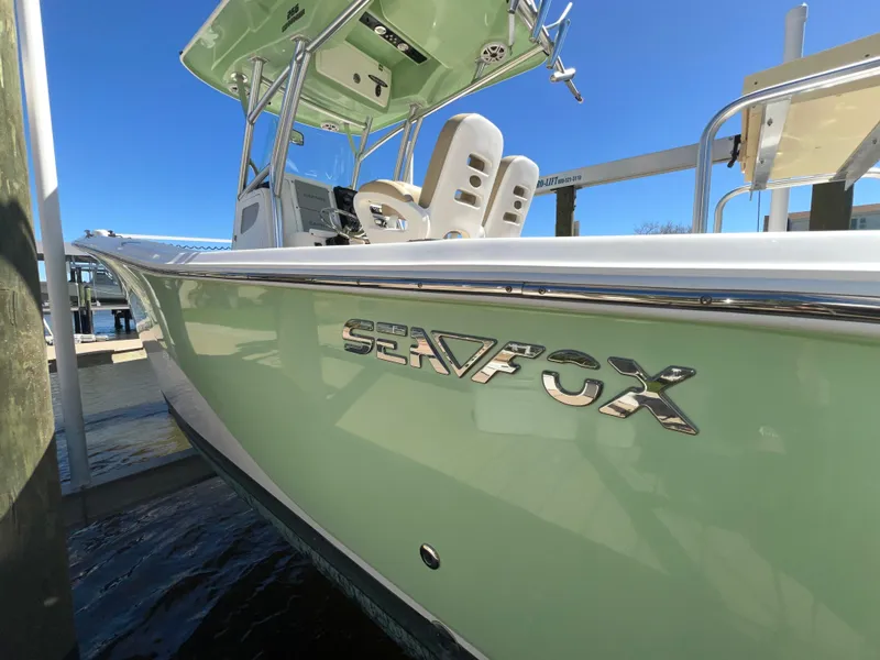 Slide: The Image of 2016 Sea Fox 266 Commander boat docked, showcasing sleek design and branding. - 38