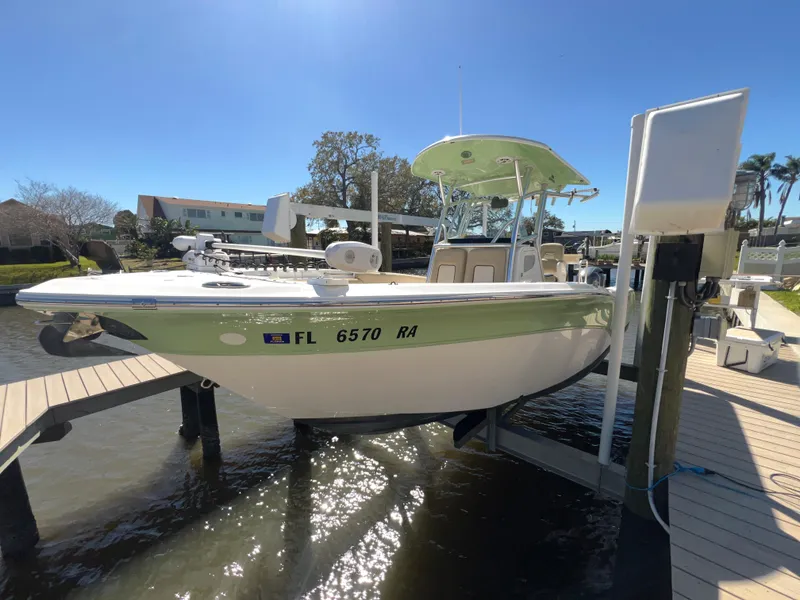 Slide: The Image of 2016 Sea Fox 266 Commander boat on lift, docked in sunny marina. - 5