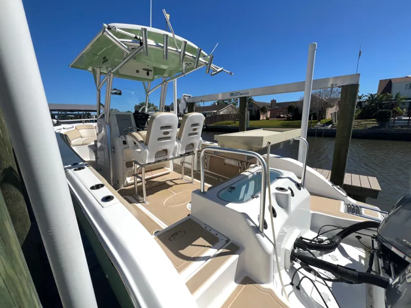 Slide: The Image of 2016 Sea Fox 266 Commander boat docked, featuring dual seats and a center console. - 6