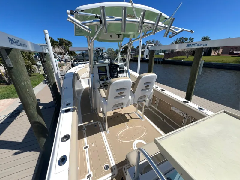 Slide: The Image of 2016 Sea Fox 266 Commander boat docked, featuring dual seats and a center console. - 7