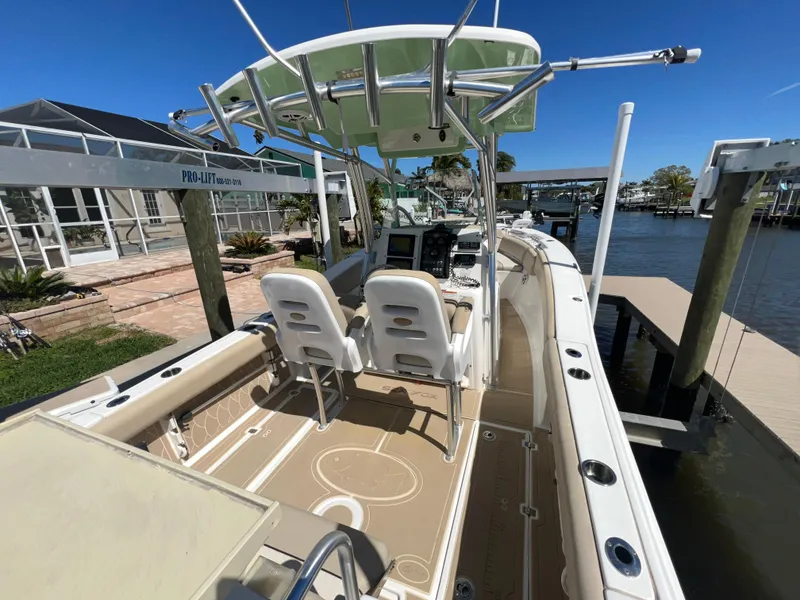 Slide: The Image of 2016 Sea Fox 266 Commander boat docked, featuring dual seats and a center console. - 8