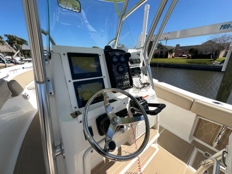 Slide: The Image of 2016 Sea Fox 266 Commander boat helm with steering wheel and navigation equipment. - 9