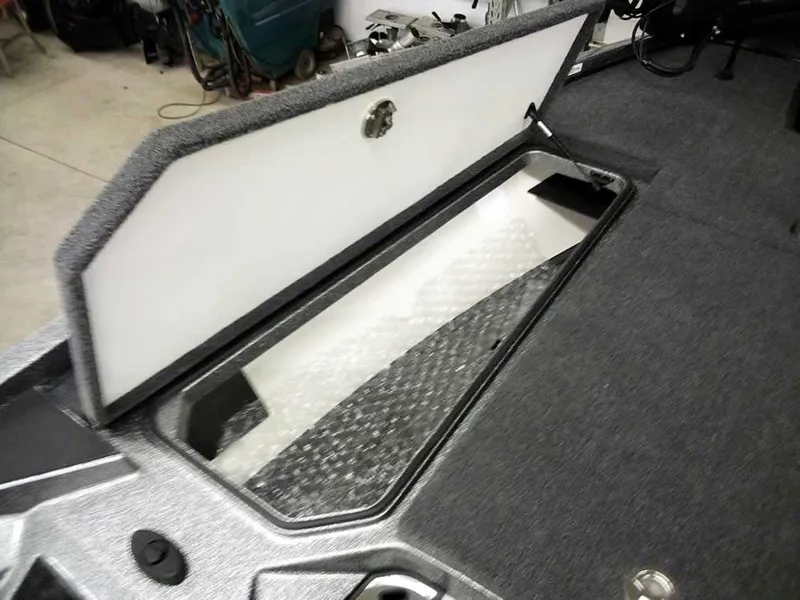 Slide: The Image of 2025 Ranger Z519R Cup-Equipped boat storage compartment, open lid, gray interior. - 17