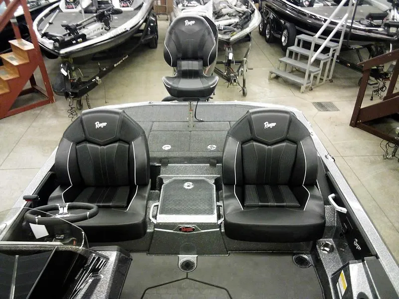 Slide: The Image of 2025 Ranger Z519R Cup-Equipped boat interior with black seats in showroom. - 21