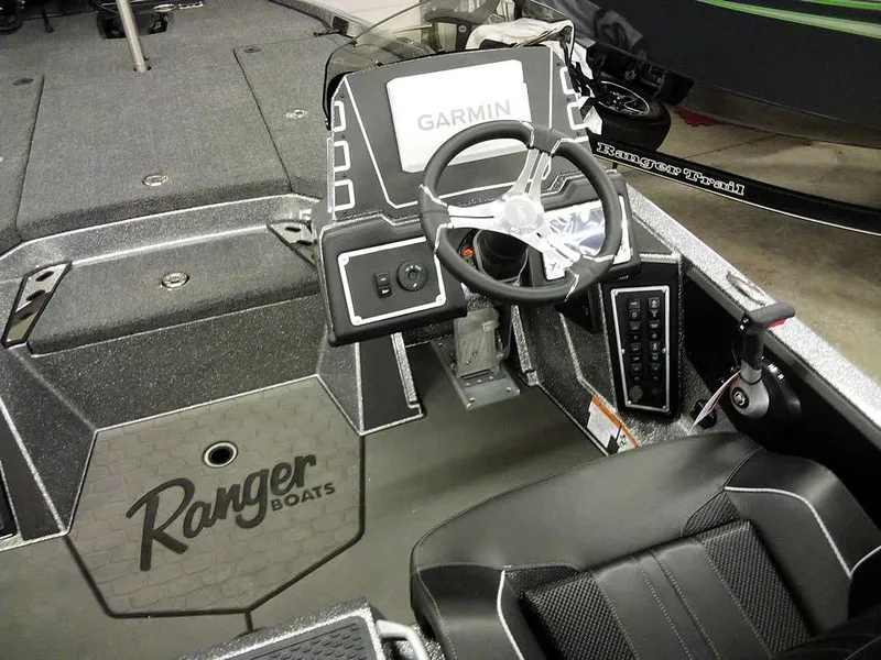 Slide: The Image of 2025 Ranger Z519R Cup-Equipped boat interior with Garmin system and steering wheel. - 26