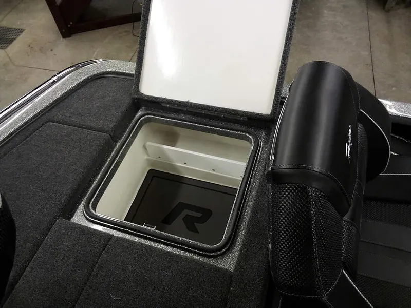 Slide: The Image of 2025 Ranger Z519R Cup-Equipped boat storage compartment with open lid, showcasing interior design. - 33