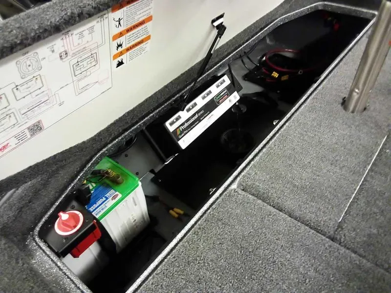 Slide: The Image of 2025 Ranger Z519R Cup-Equipped boat battery compartment with wiring and safety labels. - 35