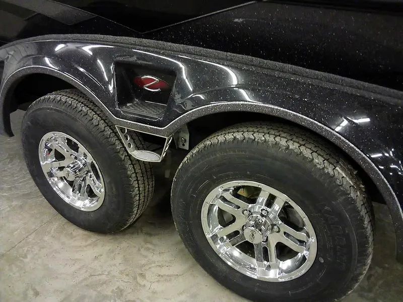 Slide: The Image of 2025 Ranger Z519R Cup-Equipped trailer with dual chrome wheels and sleek black fender design. - 7