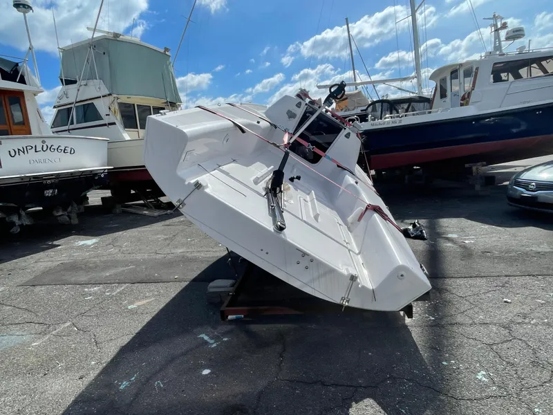 Slide: The Image of 2025 Beneteau First 24 sailboat on dry dock under a sunny sky. - 7