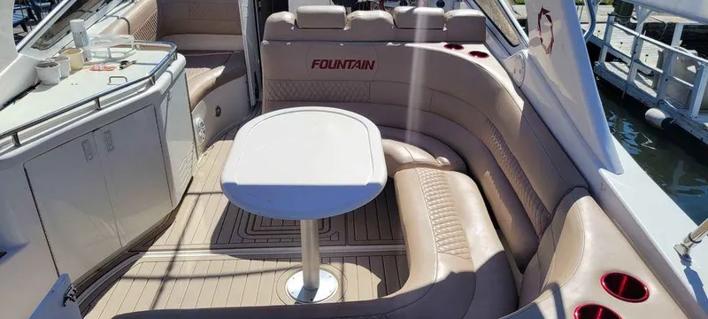 Slide: The Image of 2006 Fountain 38 Express Cruiser interior with beige seating and table. - 10