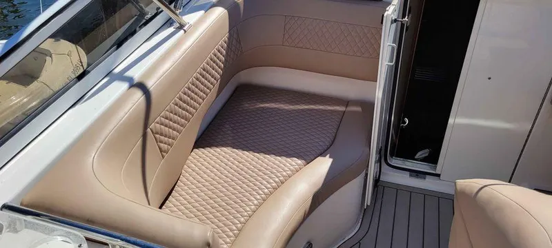 Slide: The Image of 2006 Fountain 38 Express Cruiser interior with beige quilted seating. - 11