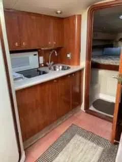 Slide: The Image of 2006 Fountain 38 Express Cruiser interior with kitchenette and cozy cabin. - 12