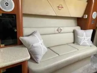 Slide: The Image of 2006 Fountain 38 Express Cruiser interior with beige seating and decorative pillows. - 16