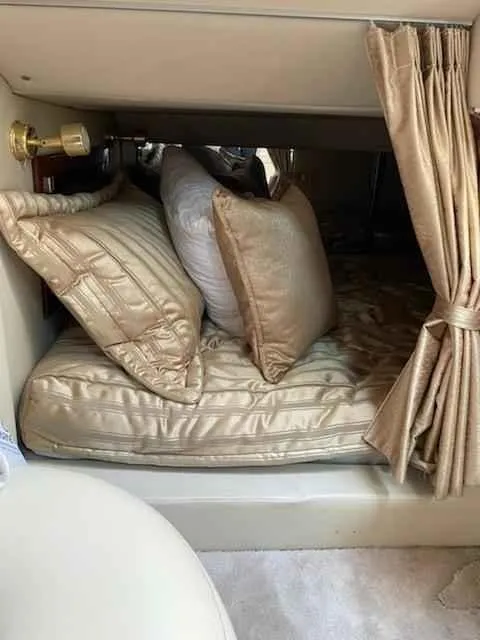 Slide: The Image of Luxurious cabin interior of a 2006 Fountain 38 Express Cruiser with plush bedding and curtains. - 18