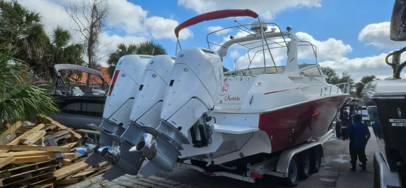 Slide: The Image of 2006 Fountain 38 Express Cruiser with triple outboard engines on trailer. - 2