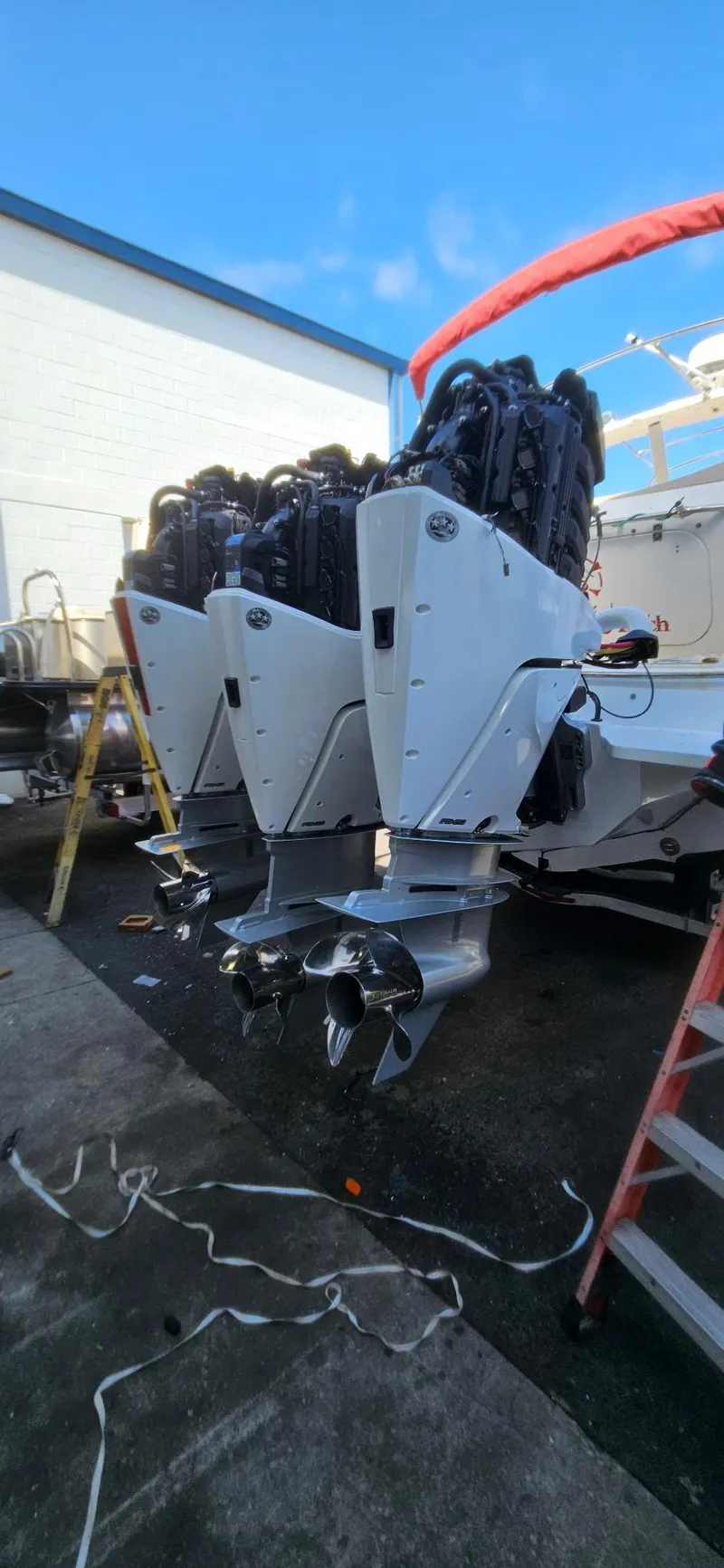 Slide: The Image of 2006 Fountain 38 Express Cruiser with triple outboard engines in a boatyard. - 20