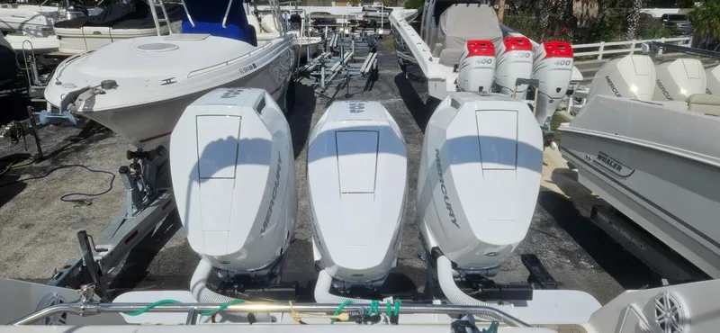 Slide: The Image of 2006 Fountain 38 Express Cruiser with triple outboard engines in a marina setting. - 23
