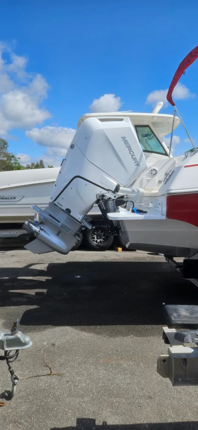 Slide: The Image of 2006 Fountain 38 Express Cruiser with Honda outboard motor, parked on a sunny day. - 24