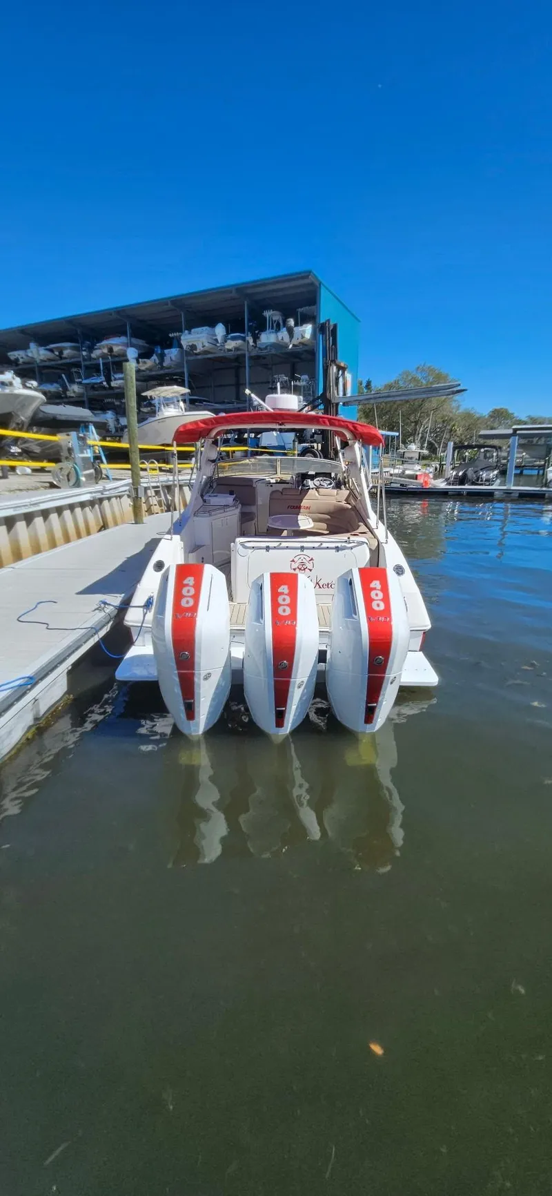 Slide: The Image of 2006 Fountain 38 Express Cruiser with triple outboard engines docked at marina. - 25