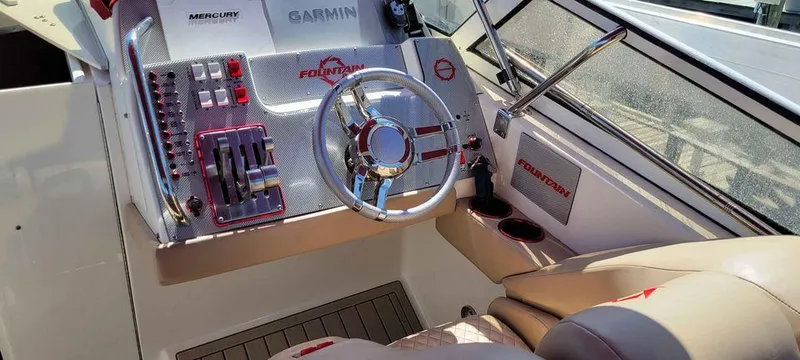 Slide: The Image of 2006 Fountain 38 Express Cruiser helm with Garmin navigation and Mercury controls. - 4